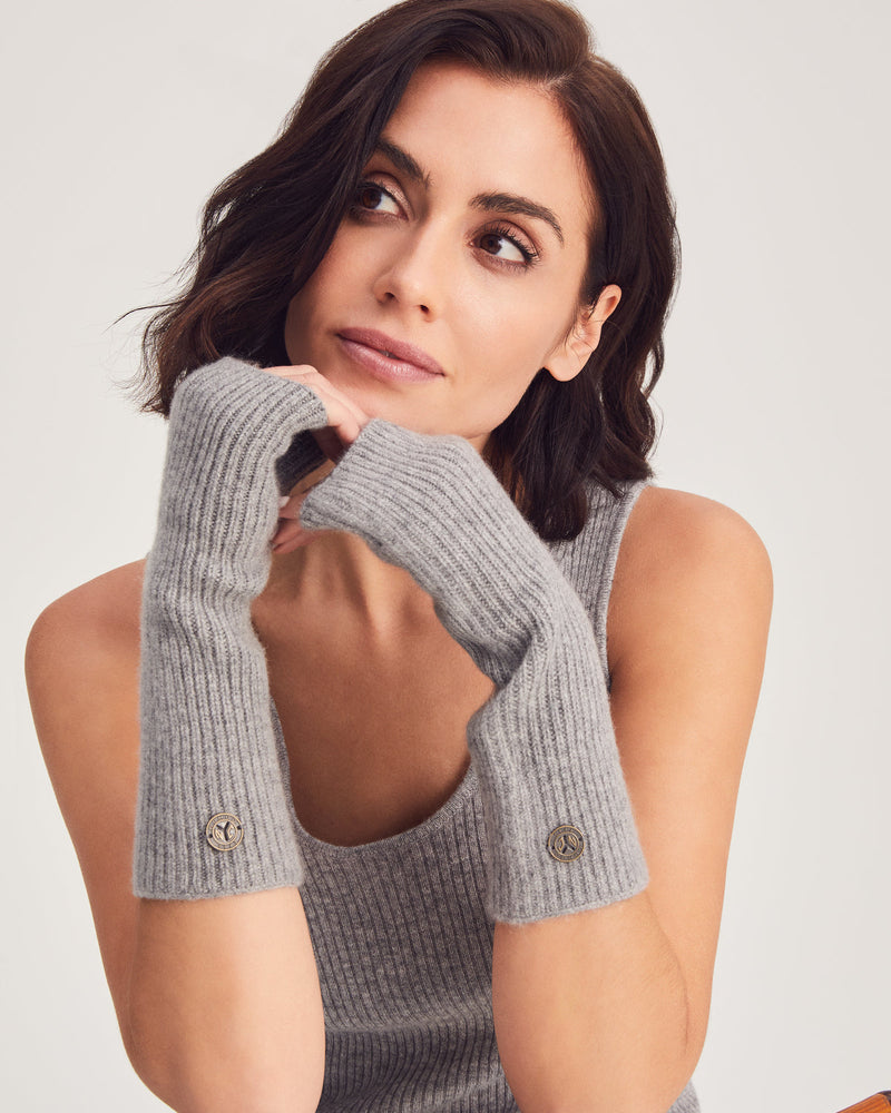 woman wearing fingerless gloves in cobblestone