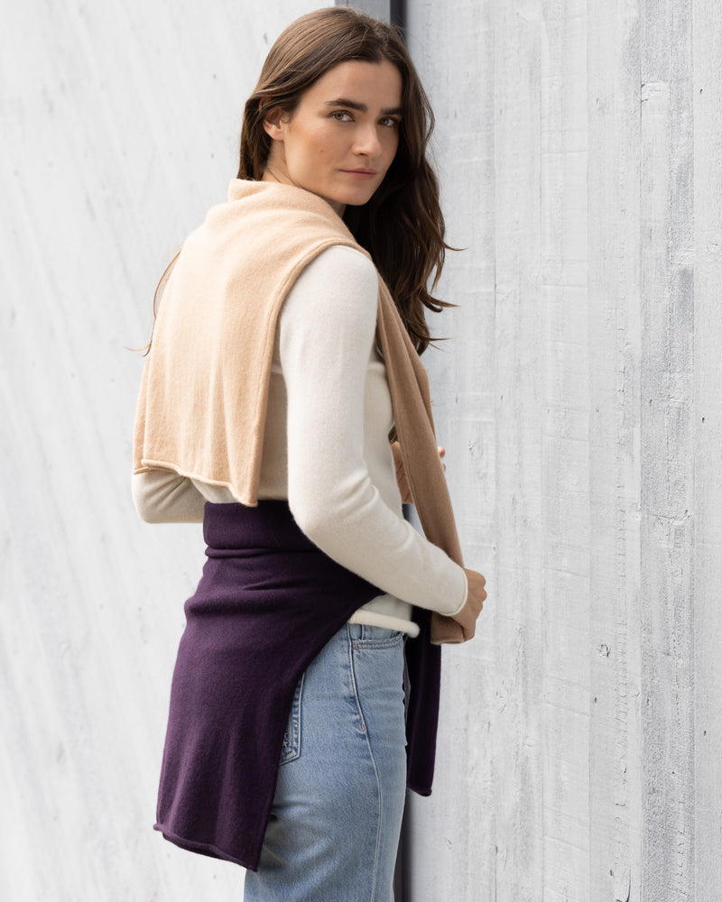 woman wearing Nomad Sweater over her shoulder in tan, around her waist in currant and crewneck in Ivory