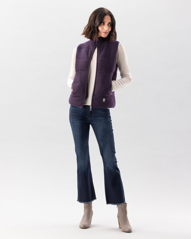 Woman wearing magnolia quilted vest in currant