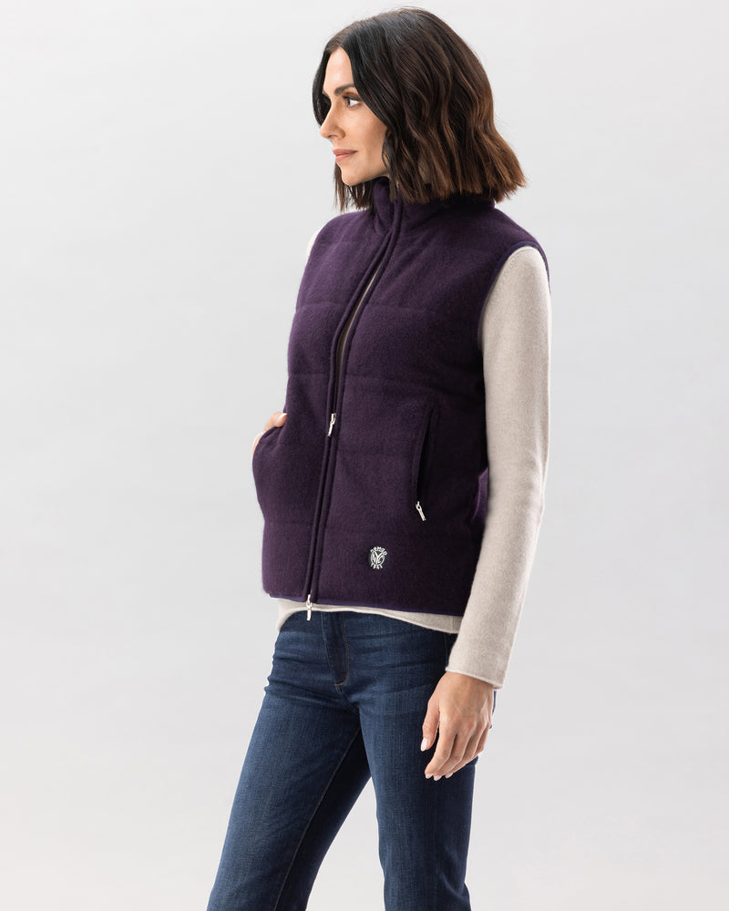 Woman wearing magnolia quilted vest in currant
