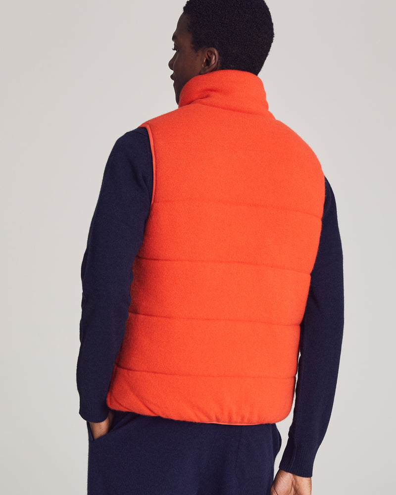 Man wearing Fordham Quilted Vest in Tangerine